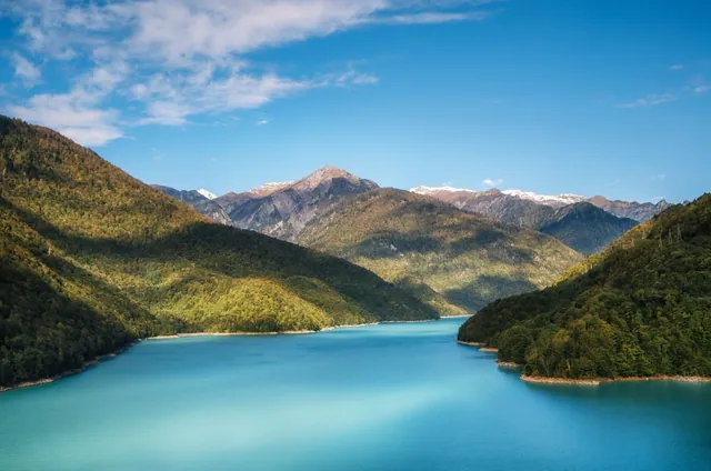 Jvari Reservoir in autumn β turquoise water and snow-capped Caucasus peaks